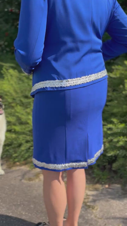 Woman wearing a royal blue dog show suit with sequin details in stretchy material. Celestite by Canis Certo.