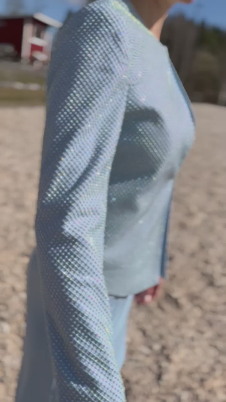 Video of female dog handler wearing a light blue, sparkly dog show handler suit. Diamond by Canis Certo.