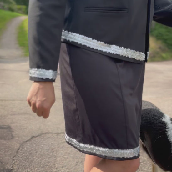 Dog handler wearing a black dog show suit with sequin details in stretchy material. Celestite by Canis Certo.