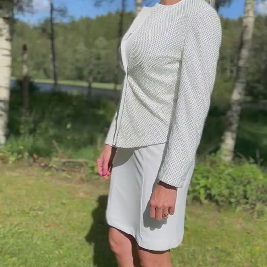 Woman wearing a white dog show suit with sparkling stones in stretchy material. Diamond by Canis Certo.