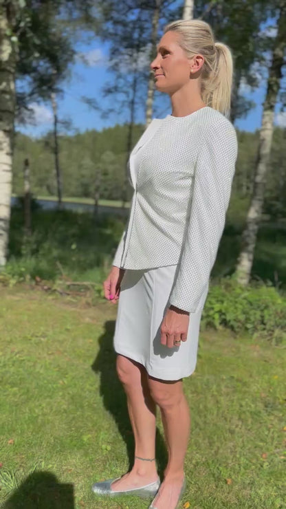 Woman wearing a white dog show suit with sparkling stones in stretchy material. Diamond by Canis Certo.
