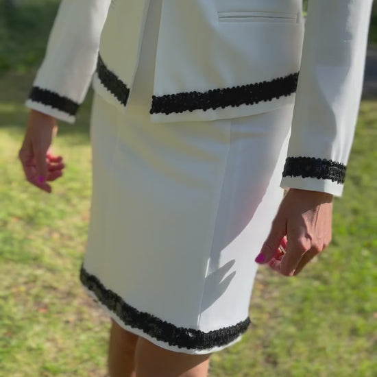 Dog handler wearing a white dog show suit with sequin details in stretchy fabric. Celestite by Canis Certo.