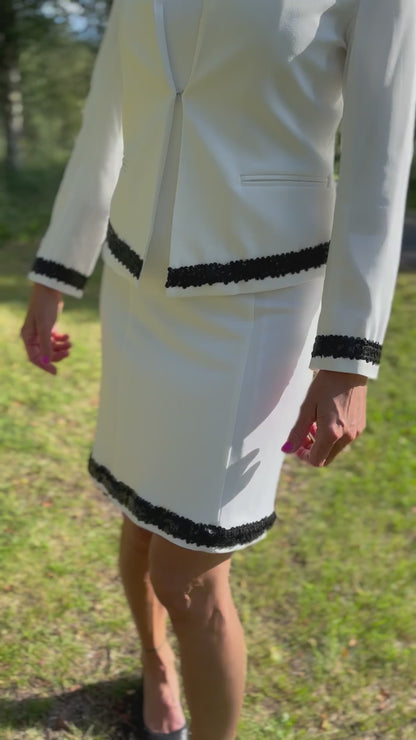 Dog handler wearing a white dog show suit with sequin details in stretchy fabric. Celestite by Canis Certo.